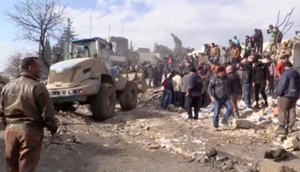 Bulldozer moving debris after a fuel truck exploded in the centre of rebel-held Azaz