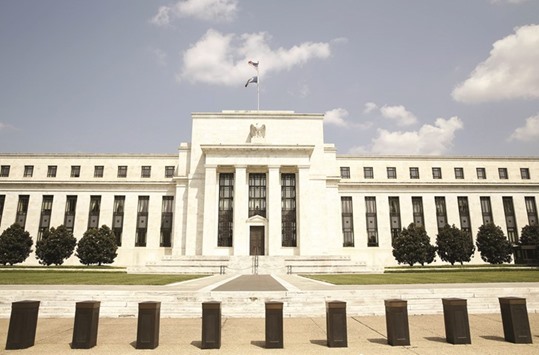 The Federal Reserve building is seen in Washington. The Fed officials voiced growing confidence on Friday that the US economy is moving closer to the central banku2019s targets on unemployment and inflation.