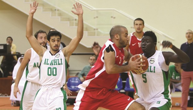 Mohammed Harat (centre) of Al Shamal attempts to get past Al Ahli defenders during the Qatar Basketball League at the Al Gharafa Sports Club, yesterday. PICTURE: Othman Iraqi