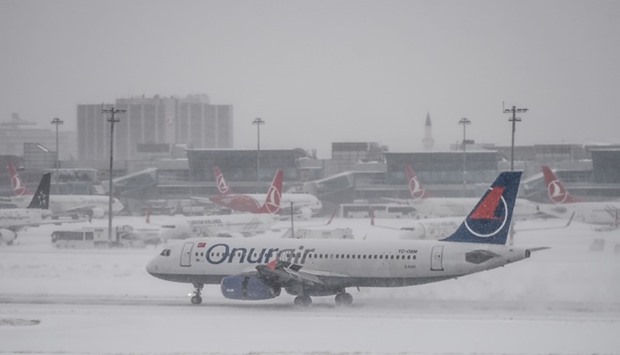 A plane lands at Ataturk international airport during snowfalls in Istanbul.
