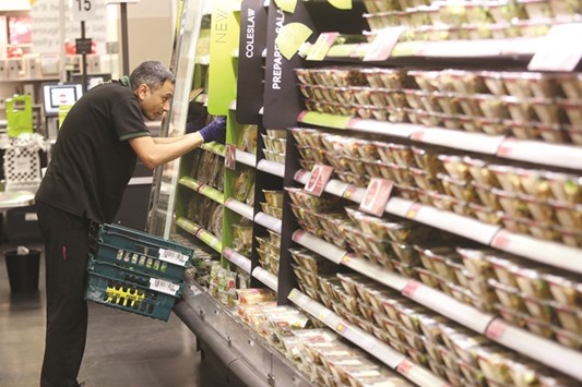 An employee replenishes a chilled fresh food cabinet inside a branch of Marks & Spencer Group in London. In November, Marks & Spencer said the impact of Brexit u201cremains uncertain,u201d citing currency volatility, confidence and the potential for new trade tariffs.