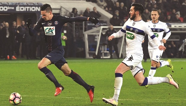 Paris Saint-Germainu2019s midfielder Julian Draxler (left) gets past Bastiau2019s defender Mathieu Peybernes during the French Cup match at the Parc des Princes stadium in Paris, on Saturday. (AFP)