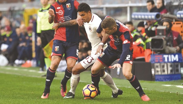 AS Romau2019s Emerson Palmieri (centre) fights for the ball with Genoau2019s Armando Izzo (left) and Serbia Darko Lazovic during the Italian Serie A match yesterday. (AFP)