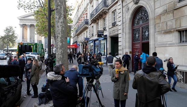 Journalists working as police officers stand guard at the entrance to a hotel residence, near Madeleine, central Paris, where US reality television star Kim Kardashian was robbed at gunpoint by assailants disguised as police who made off with millions, mainly in jewellery. File photo: October 3, 2016