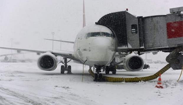 A Turkish Airlines plane is covered by frost and snow during snowfall on Monday at Ataturk international airport in Istanbul.