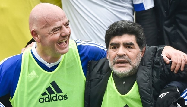 FIFA president Gianni Infantino (L) and Argentinian retired professional footballer Diego Armando Maradona (R) 