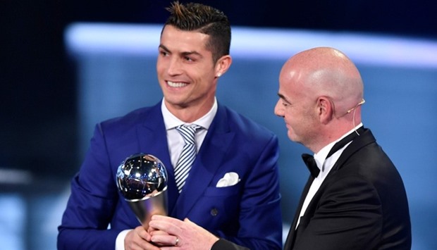 Real Madrid and Portugal's forward Cristiano Ronaldo (L) is presented with The Best FIFA Menu2019s Player of 2016 Award by FIFA president Gianni Infantino
