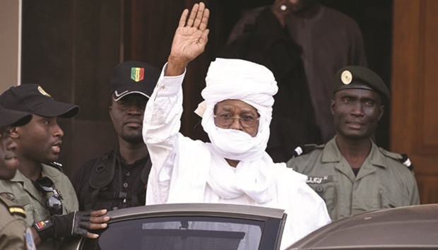 This file photo taken on June 3, 2015 shows Habre waving while leaving the Dakar courthouse.