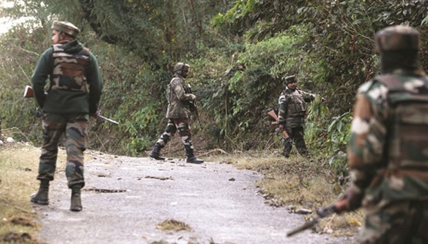 Soldiers take position during an encounter with suspected militants near a General Engineering Reserve Force (GERF) camp in the village of Batal in Akhnoor district some 50km north of Jammu yesterday.