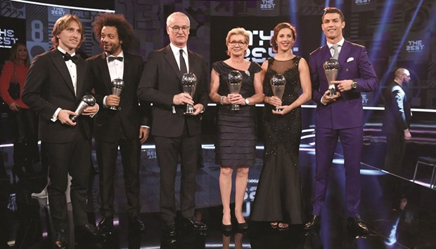 (LtoR) Awardees of the FIFA FIFPro World11 award, Real Madrid and Croatiau2019s midfielder Luka Modric and Real Madrid and Brazilu2019s defender Marcelo, Leicester Cityu2019s Italian manager and winner of The Best FIFA Menu2019s Coach of 2016 Claudio Ranieri, Germanyu2019s former head coach and winner of The Best FIFA Womenu2019s Coach of 2016 Award Silvia Neid, Houston Dash and US midfielder and winner of The Best FIFA Womenu2019s Player of 2016 Award Carli Lloyd and Real Madrid and Portugalu2019s forward and winner of The Best FIFA Menu2019s Player of 2016 Award Cristiano Ronaldo pose with their trophies on stage during the FIFA Football Awards 2016 ceremony yesterday.