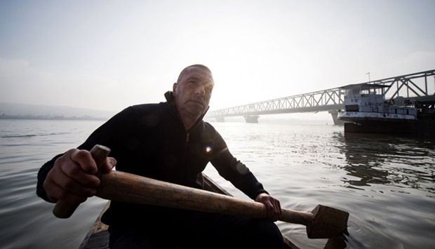 Renato Grbic paddles trough the river Danube close to the Pancevo Bridge in Belgrade.