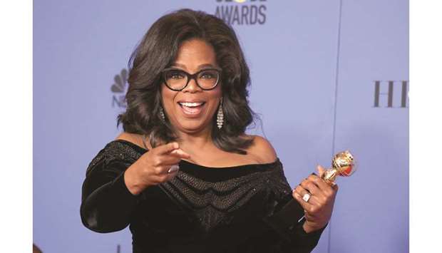 Oprah Winfrey poses backstage with her Cecil B DeMille Award at the 75th Golden Globe Awards in Beverly Hills, California, on Sunday night.