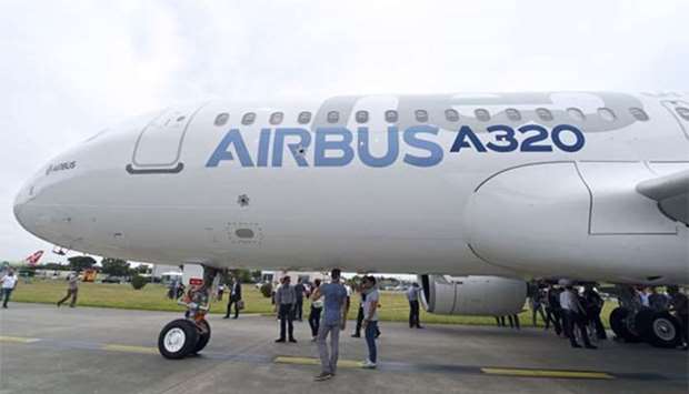 Airbus staff looking at a Airbus A320neo passenger plane. China has ordered 184 Airbus A320 planes to be delivered to 13 airlines, French officials said on Wednesday.