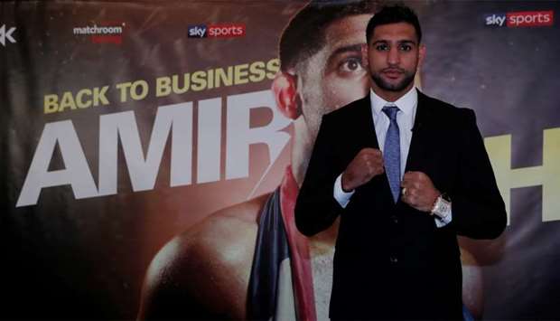 Amir Khan poses after the press conference