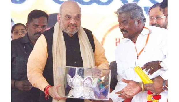 BJP president Amit Shah being presented with a silver lotus, the partyu2019s symbol, during a function in Bengaluru yesterday.