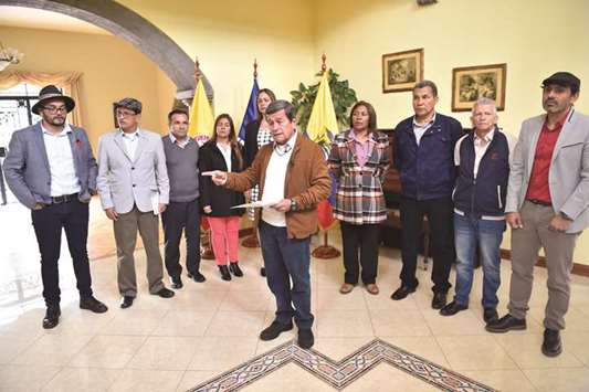 The chief negotiator of the ELN guerrilla in the talks with the Colombian government, Pablo Beltran (centre), reads a statement calling the government of President Juan Manuel Santos to reconsider its withdrawal from peace negotiations, insisting they wanted to talks to continue, at Hacienda Cashapamba in Sangolqui, Ecuador, yesterday.