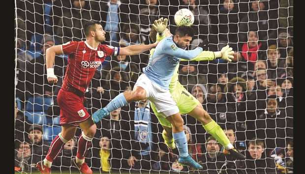 Manchester Cityu2019s Sergio Aguero (centre) jumps to score during the English League Cup semi-final first leg match against Bristol City on Tuesday night. (AFP)