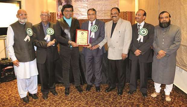 HONOUR: Fartash Syed, fourth from left, being presented a shield by M S Bukhari, third from left, on behalf of Urdu literary organisations of the Indian community in Qatar.
