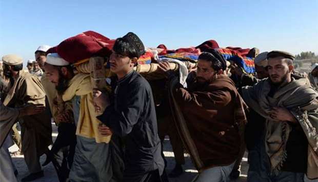 Afghan mourners carry the coffin of one of the 13 victims of a suspected US airstrike in the Achin district of Nangarhar province on Friday.