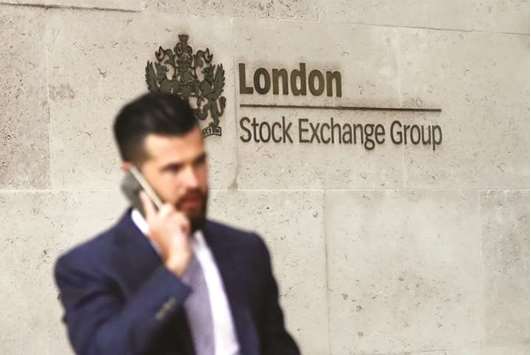 A pedestrian walks past the London Stock Exchange. The FTSE 100 gained 0.2% to 7,778.64 points yesterday.