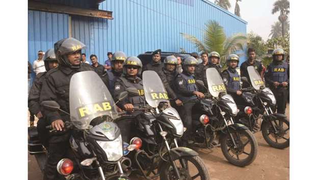 Members of anti-crime elite force Rapid Action Battalion (RAB) are seen ready for action in Dhaka.