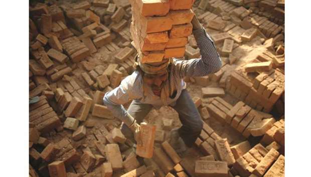 A worker stacks bricks on his head at a brick factory in Bhaktapur, near Kathmandu.