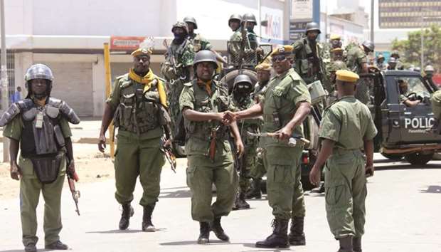 Zambian police forces patrol the streets of Lusakau2019s Kanyama Township, yesterday, during clashes with protesters demonstrating against a curfew and a ban on street commerce imposed by the government in the wake of a cholera outbreak.