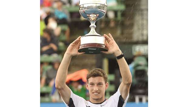 Pablo Carreno Busta of Spain holds the trophy after defeating Matthew Ebden of Australia in the final of the Kooyong Classic tennis tournament in Melbourne yesterday.