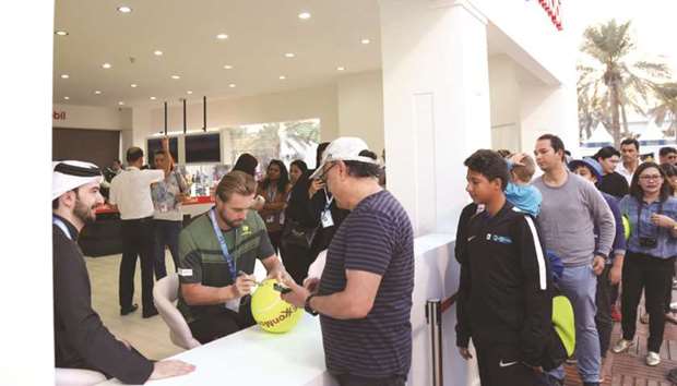 Fans have a chance to get autographed tennis balls at the ExxonMobil stand in the Public Village.