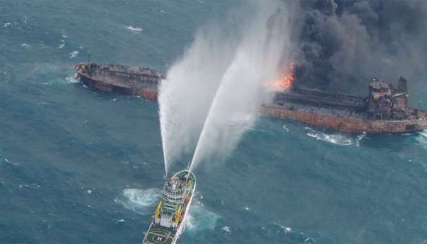 A rescue ship works to extinguish the fire on the stricken Iranian oil tanker Sanchi in the East China Sea