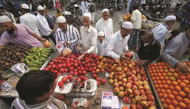 People buy fruits and vegetables at a market in Ahmedabad. Indiau2019s consumer food price index in December stood at 4.96% compared to 4.42% in November 2017.