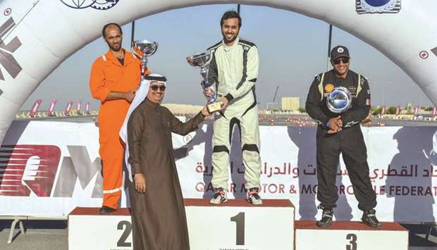 Abdullah al-Khelaifi is presented with his trophy at the Losail International Circuit yesterday.
