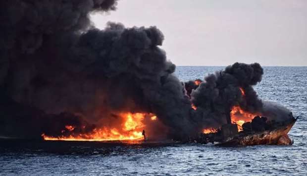 Smoke and flames coming from the burning oil tanker ,Sanchi, at sea off the coast of eastern China