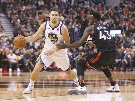 Golden State Warriors guard Klay Thompson (left) dribbles around Toronto Raptors forward Pascal Siakam during the first half of their NBA game at the Air Canada Centre. PICTURE: USA TODAY Sports