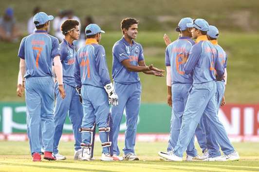 Shivam Mavi (centre) of India celebrates a wicket with teammates during the ICC U19 World Cup match against Australia in Tauranga, New Zealand. (ICC/Getty Images)
