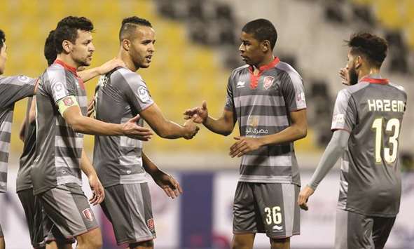 Al Duhailu2019s Youssef El Arabi (second from left) scored a hat-trick in the win against Qatar SC on Saturday.