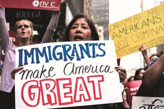 Protesters demonstrate against President Donald Trump during a rally in support of the Deferred Action for Childhood Arrivals near Trump Tower in New York on October 5, 2017.
