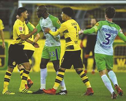 Borussia Dortmundu2019s Mahmoud Dahoud (left) and Wolfsburgu2019s Josuha Guilavogui argue during the Bundesliga match in Dortmund, Germany, yesterday. (AFP)
