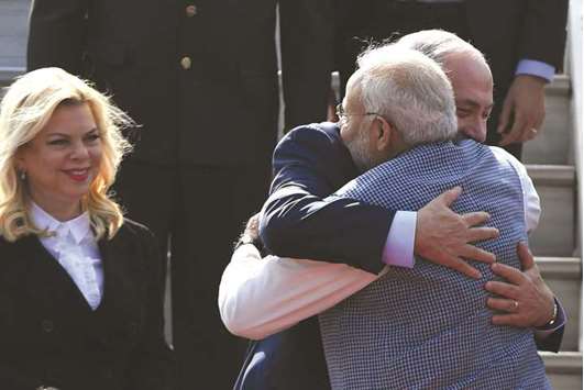 Indian Prime Minister Narendra Modi welcomes Israeli Prime Minister Benjamin Netanyahu and his wife Sara Netanyahu on their arrival at the Air Force Station in New Delhi yesterday.