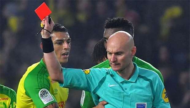 Nantes' Brazilian defender Diego Carlos receives a red card from French referee Tony Chapron during the French L1 match between Nantes and Paris Saint-Germain at the La Beaujoire stadium in Nantes, western France, on Sunday.