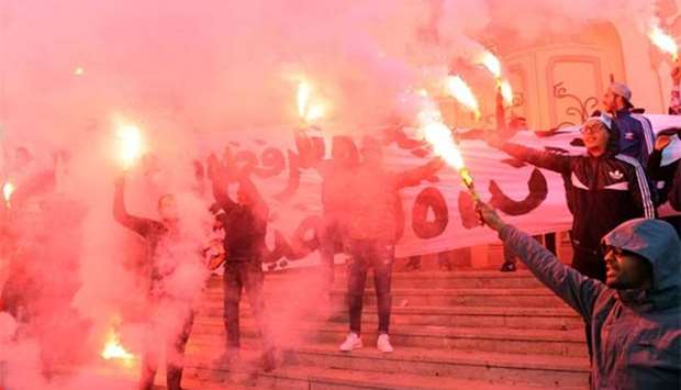 Tunisian protesters carry flares and shout slogans during celebrations in central Tunis on Sunday, marking the seventh anniversary since the uprising that ousted ex-president Zine El Abidine Ben Ali and launched the Arab Spring.