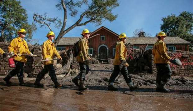 Rescue workers enter properties to look for missing persons after a mudslide in Montecito, California, late last week.