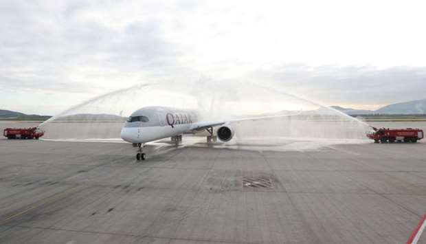 Qatar Airways' ultra-modern A350 receives a traditional water canon salute at Athens International Airport