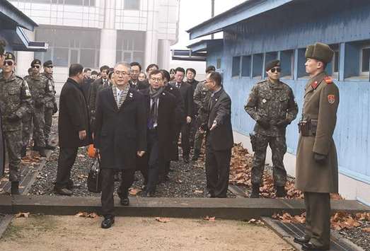 South Koreau2019s chief delegate Lee Woo-Sung (front left), a senior official at Seoulu2019s Culture Ministry, and his delegation crossing the border line to attend inter-Korea talks on the Northu2019s side of the border at the truce village of Panmunjom in the Demilitarized Zone (DMZ) dividing the two Koreas, yesterday.