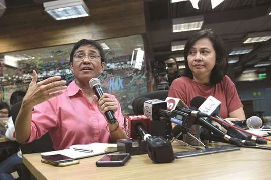 Maria Ressa (left), CEO, and editor of online portal Rappler, speaks during a press conference at their office in Manila yesterday, while acting managing editor Chay Hofilena listens.