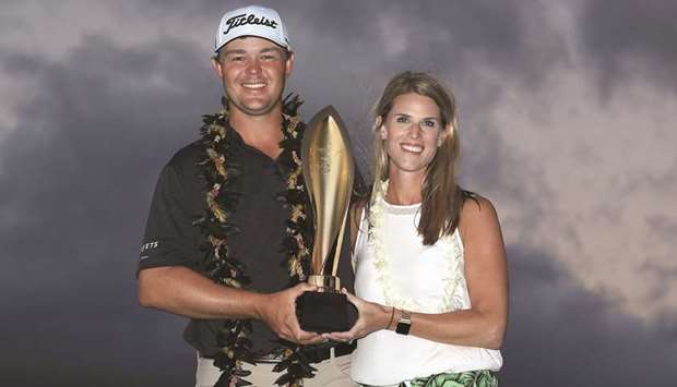 Patton Kizzire of the United States poses with his wife Kari and the trophy after winning the Sony Open in Hawaii on the sixth playoff hole against James Hahn (not pictured) at Waialae Country Club in Honolulu, Hawaii. (Getty Images/AFP)