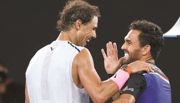 Rafael Nadal of Spain shares a laugh with Victor Estrella Burgos of Dominican Republic after their first round match.