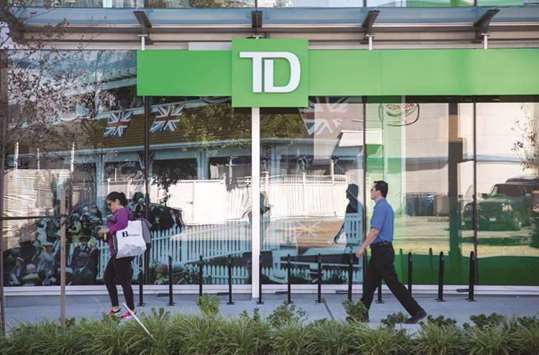 Pedestrians pass in front of a Toronto-Dominion (TD) Canada Trust bank branch in Vancouver. The proposed class-action dispute names Toronto-Dominion Bank, Royal Bank of Canada, Bank of Nova Scotia, Bank of Montreal, Canadian Imperial Bank of Commerce and National Bank of Canada, as well as HSBC Holdings, Bank of America Corp and Deutsche Bank.