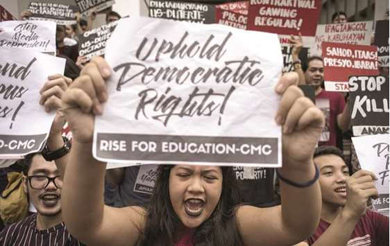 Students of the University of the Philippines participate in a protest to defend press freedom in Manila, yesterday.