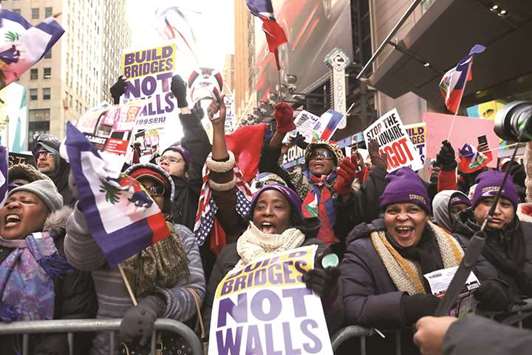 Hundreds of people, many of them Haitian, demonstrate against racism in Times Square on Martin Luther King Day in New York City on Monday. Across the country activists, politicians and citizens alike are reacting to recent comments made by President Donald Trump that appeared to denigrate both Haiti and African nations during a meeting on immigration.